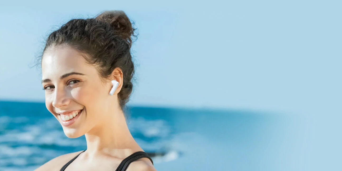 Smiling woman with Haylou MoriPods ANC